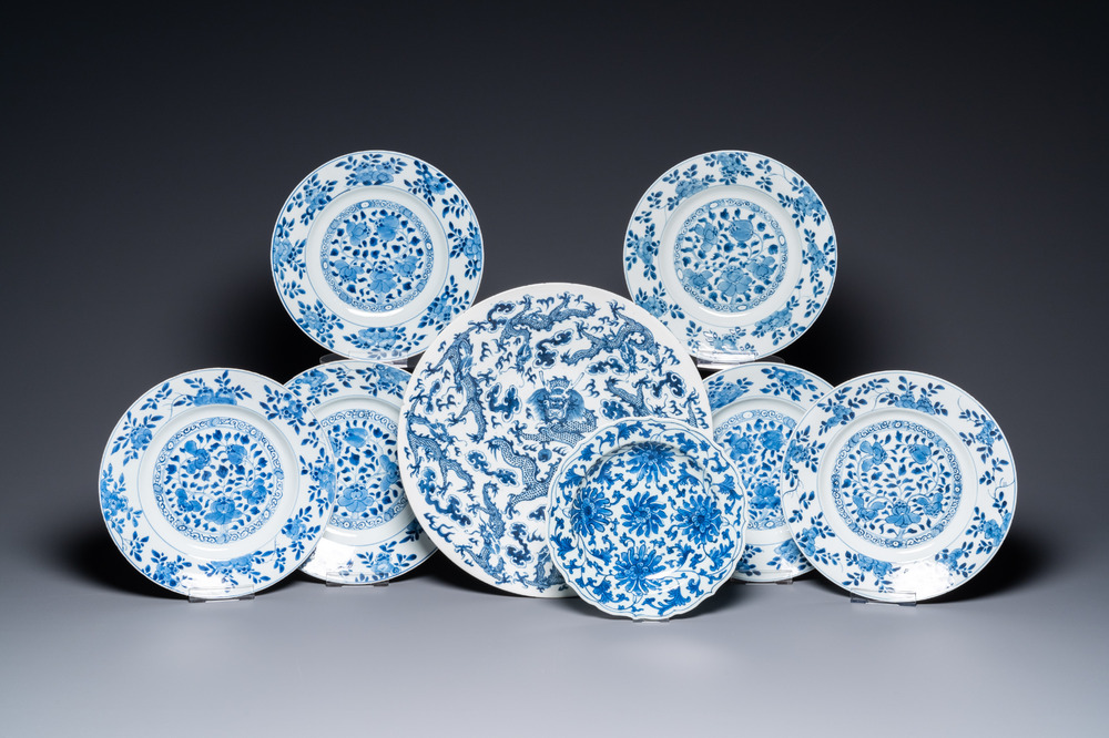 A Chinese blue and white 'dragon' dish and seven floral plates, Kangxi and later