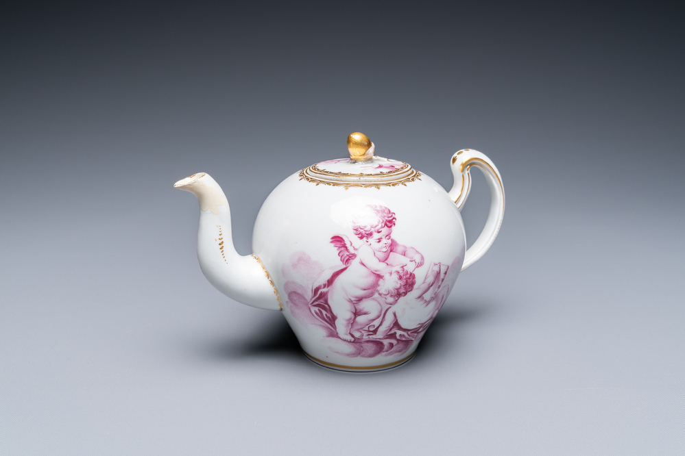A Tournai porcelain teapot and cover with purple and gilt design of putti, gilt swords and crosses mark, ca. 1765