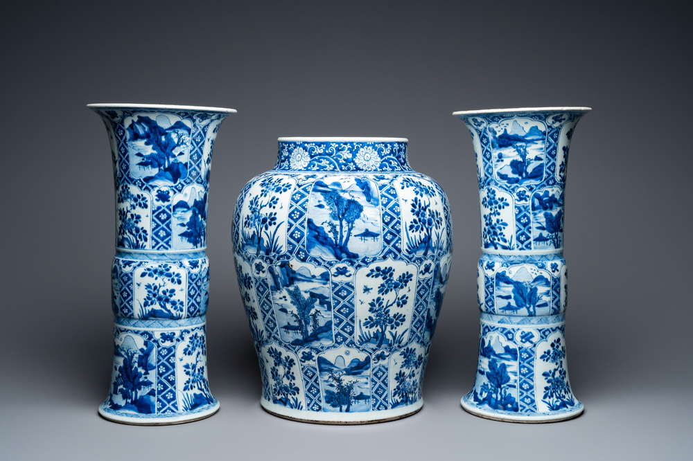 A large Chinese blue and white garniture of three vases, Kangxi