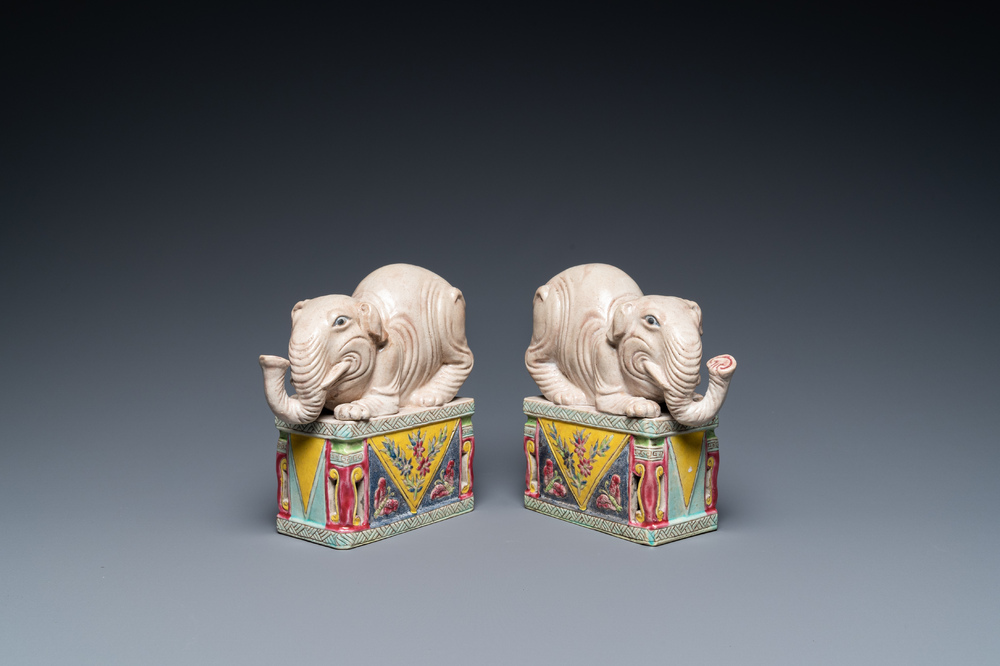 A pair of Chinese famille rose elephants on stands, 20th C.