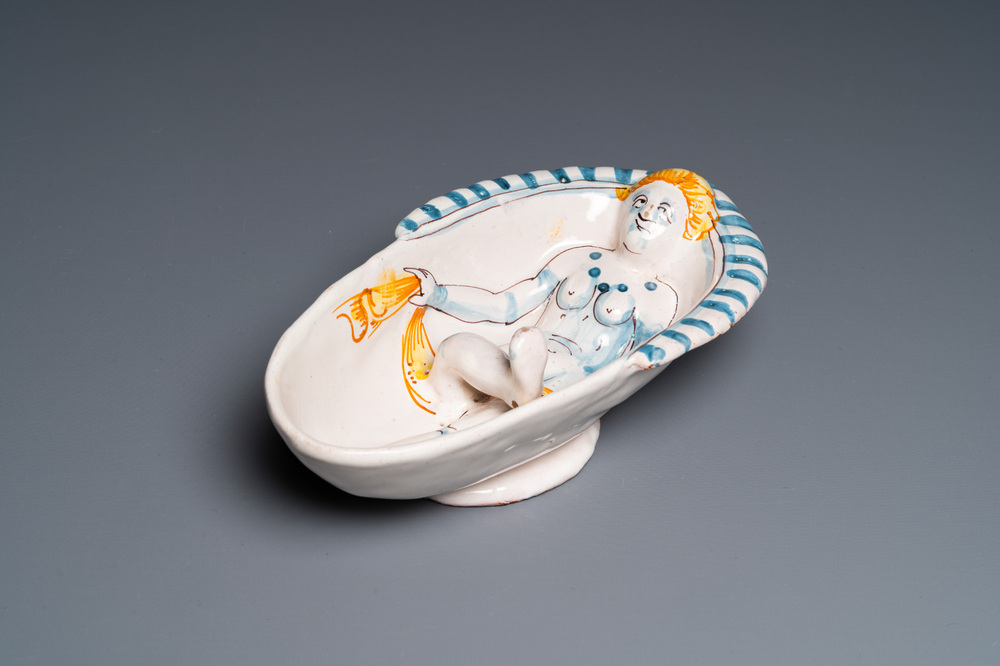 A polychrome French faience oval basin with a bathing woman, Nevers, 17th C.