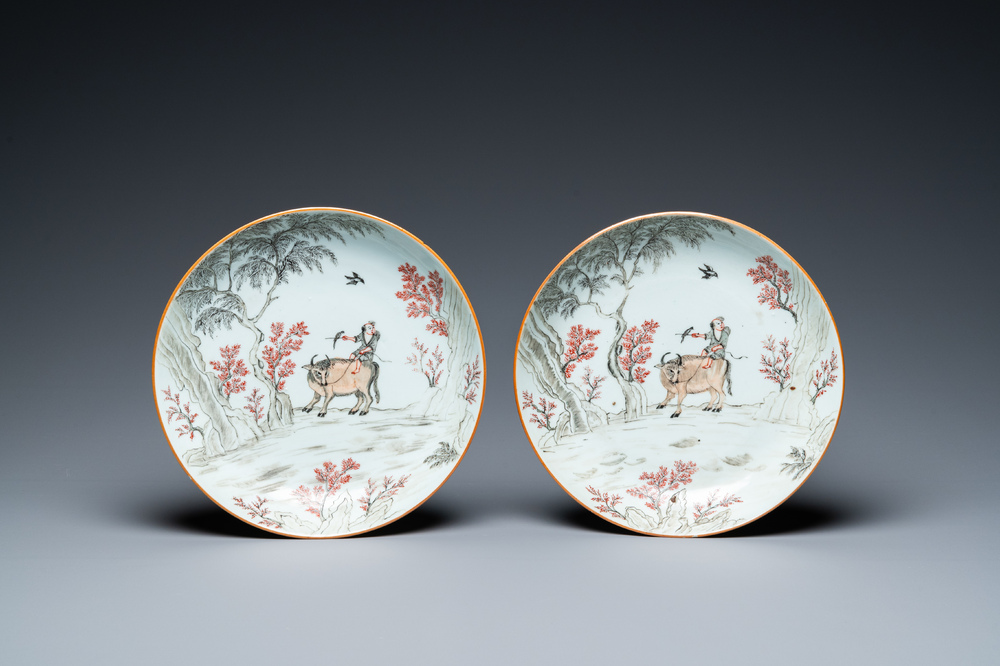 A pair of Chinese iron-red and grisaille 'boy on buffalo' plates, Qianlong
