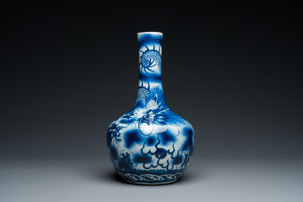 A Chinese blue and white 'dragons' bottle vase, 19th C.