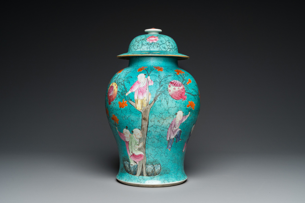A Chinese turquoise-ground famille rose 'boys at a pomegranate tree' vase and cover, 19th C.