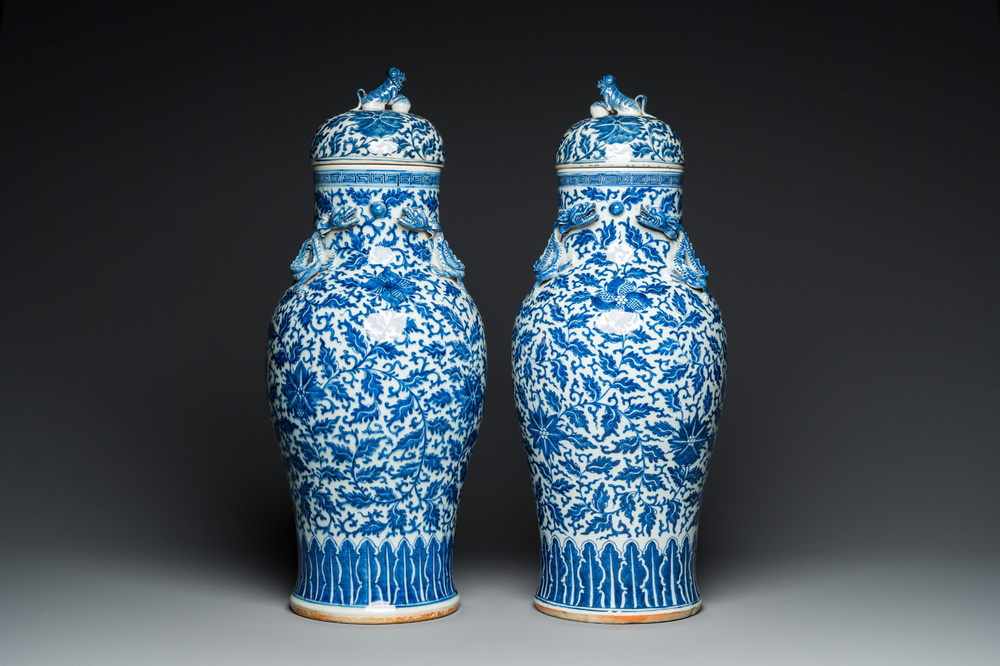 A pair of Chinese blue and white covered vases with floral sprigs, 19th C.