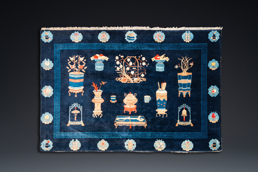 A large Chinese blue-ground 'antiquities' rug, 19th C.