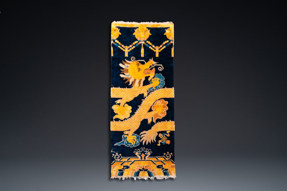 A Chinese silk 'dragons' carpet, 19th C.