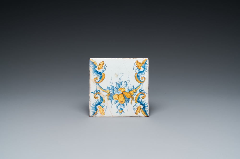 An extremely rare polychrome Dutch Delft tile with guirlands and mascarons, 17th C.