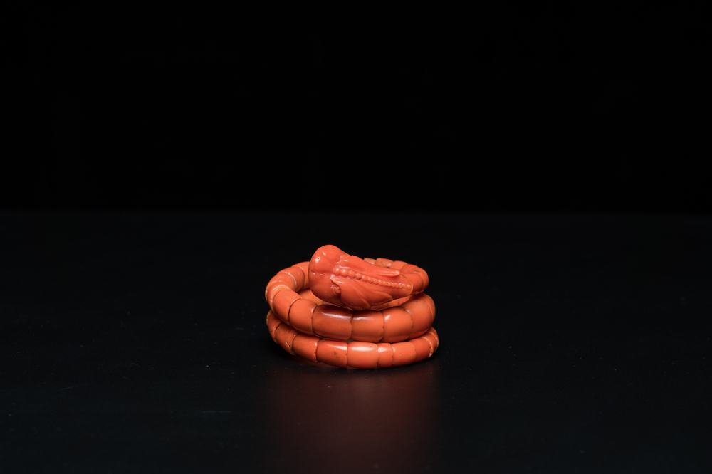A Chinese red coral bracelet with a dragon's or snake's head, 19th C.