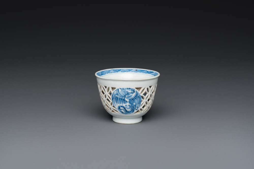 A rare Chinese reticulated double-walled blue and white 'phoenix' cup, Kangxi