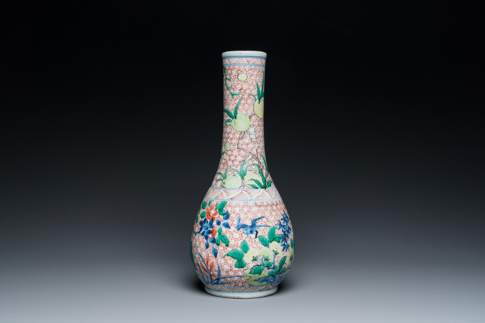 A Chinese wucai bottle vase with birds surrounded by fruits and foliage, Transitional period