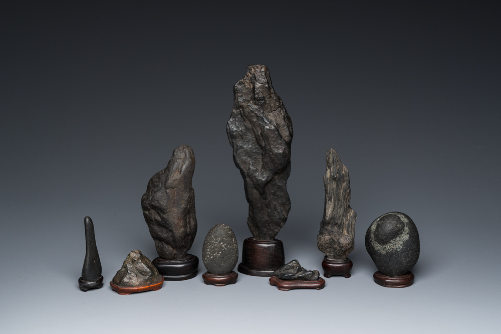 Eight Chinese 'gongshi or 'scholar's rocks' on wooden stands, Republic