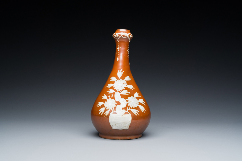 A Chinese slip-decorated brown-ground bottle vase, Zhushan kilns, late Ming