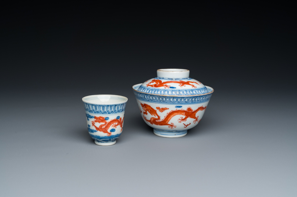 A Chinese blue, white and iron-red 'dragon' bowl and cover and a wine cup, Qianlong mark, 18/19th C.