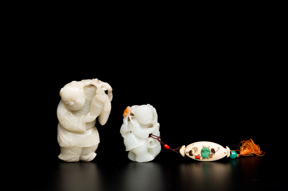 Two Chinese white and celadon jade carved standing boys, Qing
