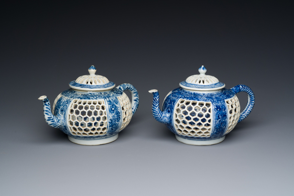 A pair of Chinese reticulated and double-walled blue and white teapots, Transitional period