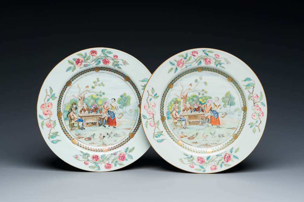 A pair of Chinese famille rose plates with peasants playing cards in the style of the painter David Teniers II, Qianlong