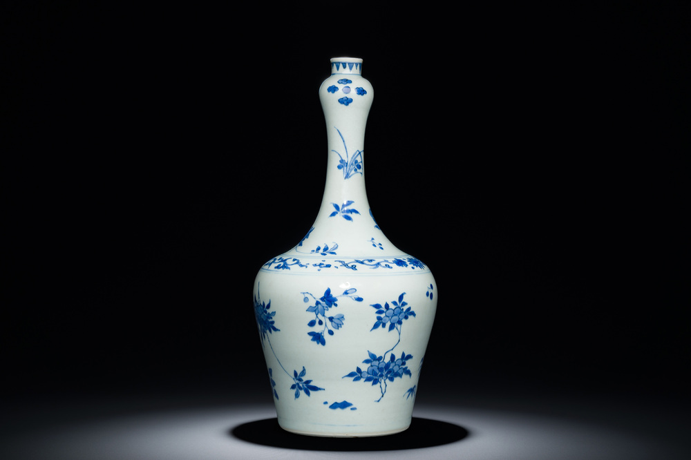 A Chinese blue and white bottle vase with floral designs, Transitional period