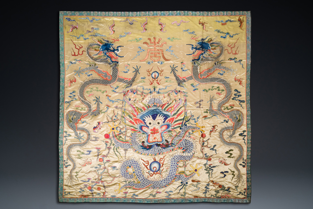 A large Chinese yellow-ground silk embroidery decorated with three five-clawed dragons, 19th C.
