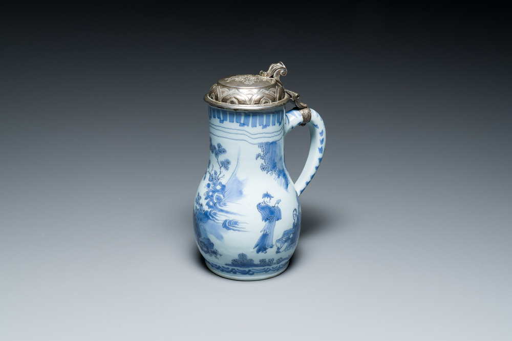A Dutch Delft blue and white chinoiserie jug with silver lid, 17th C.