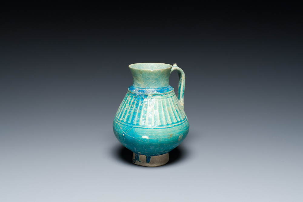 A turquoise-glazed jug, Kashan, Persia, 13th C.