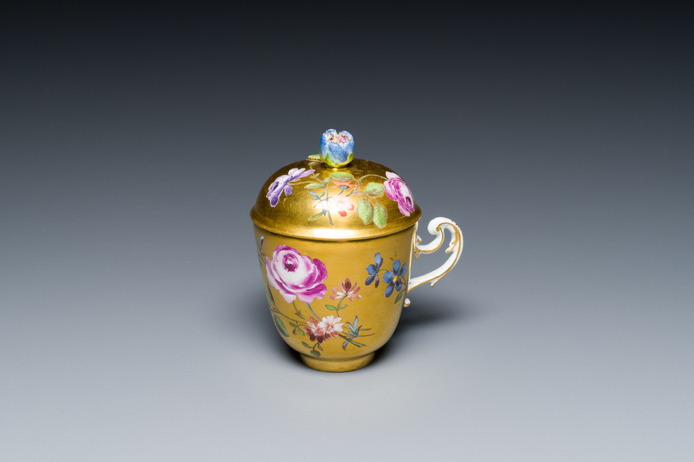 A polychrome gilt-ground Meissen porcelain cup and cover, Germany, 18th C.