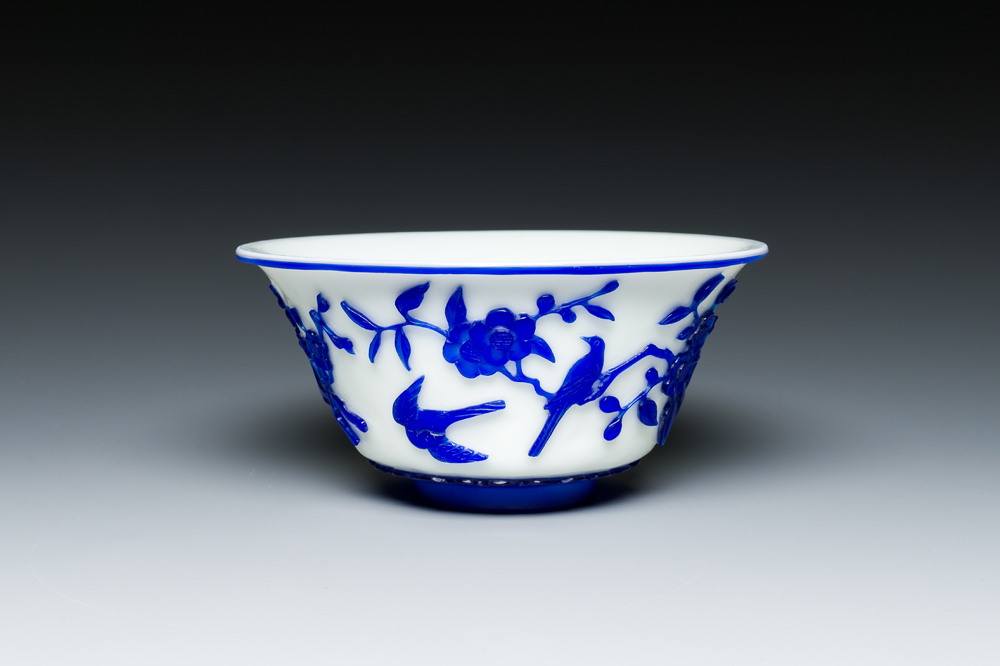 A Chinese overlay Beijing glass 'magpie and plum blossom' bowl in blue on white, 19th C.