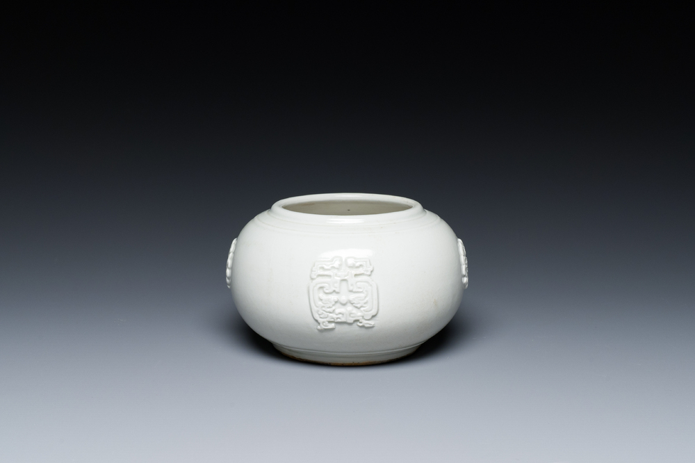 A Chinese white-glazed relief-molded bowl, Qianlong mark, 19th C.