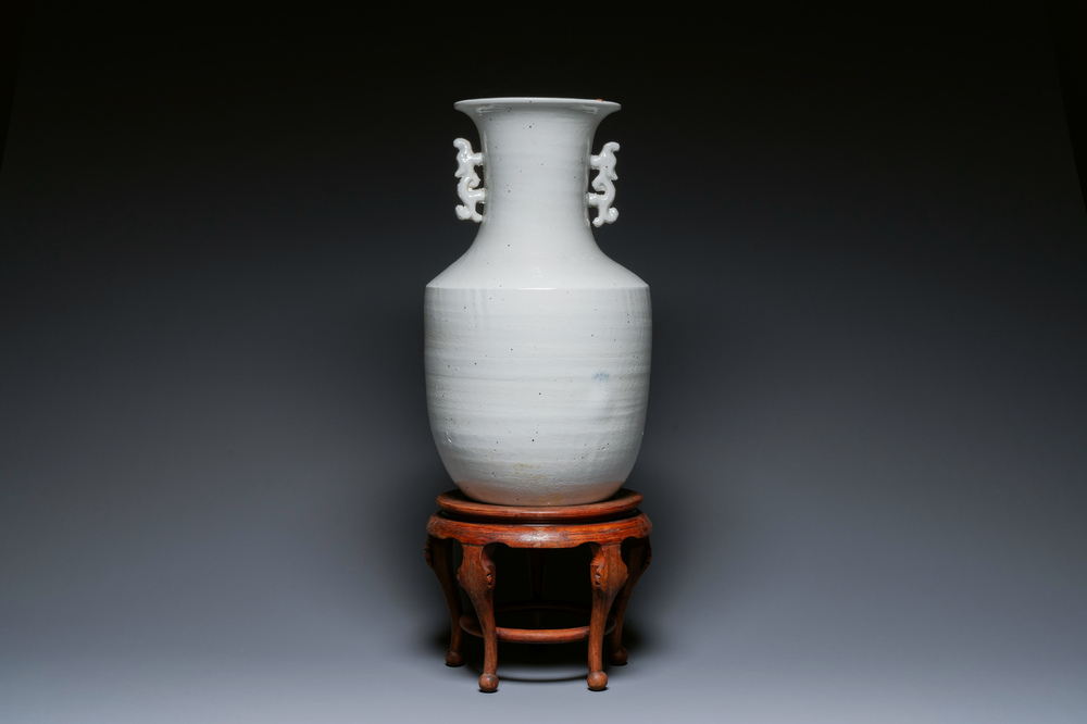 A Chinese white-glazed vase on wooden stand, 19th C.