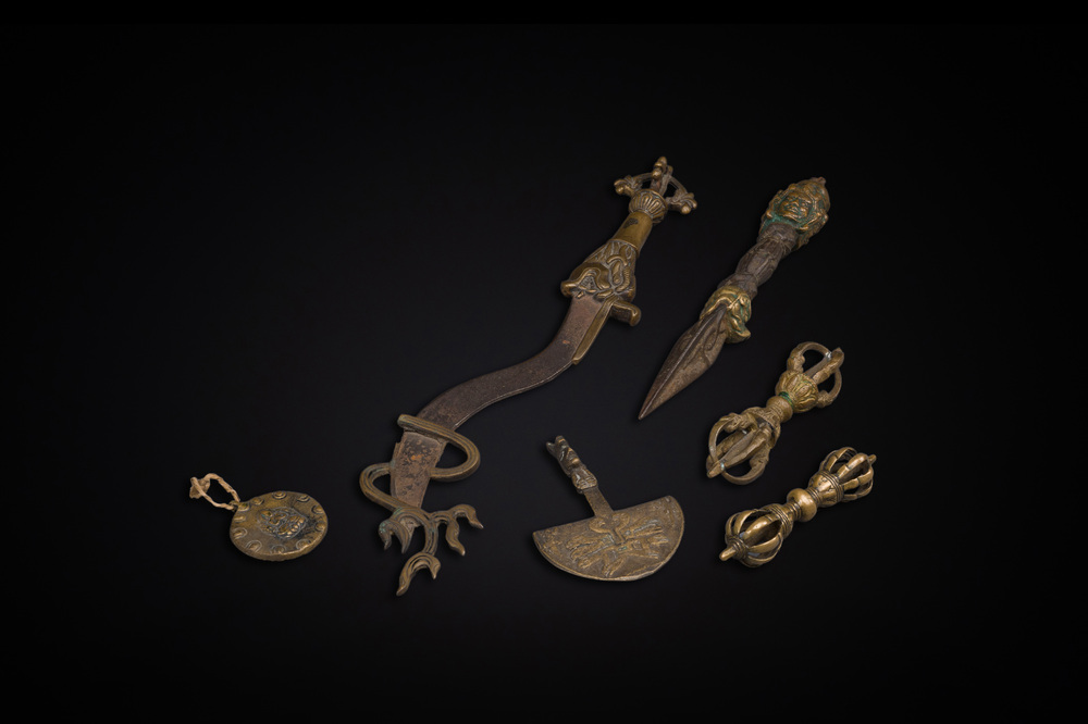 A varied collection of Tibetan bronze, iron and copper alloy ritual instruments, 14th C. and later