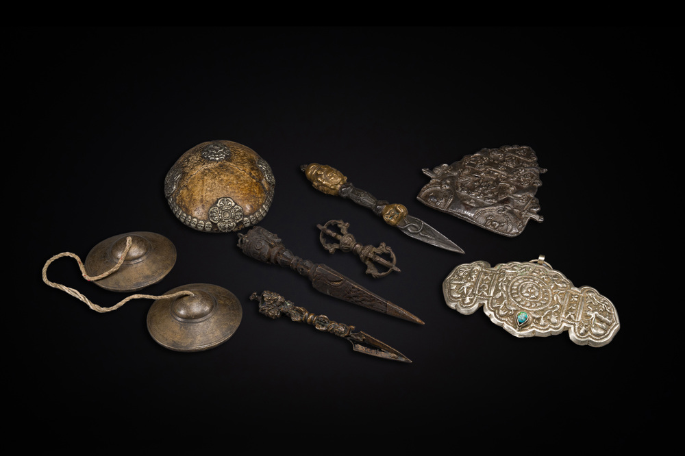Four Tibetan bronze and wooden phurbas, a 'kapala' or skull-bowl, a pair of brass tingsha and two silver ornaments,  19th C.