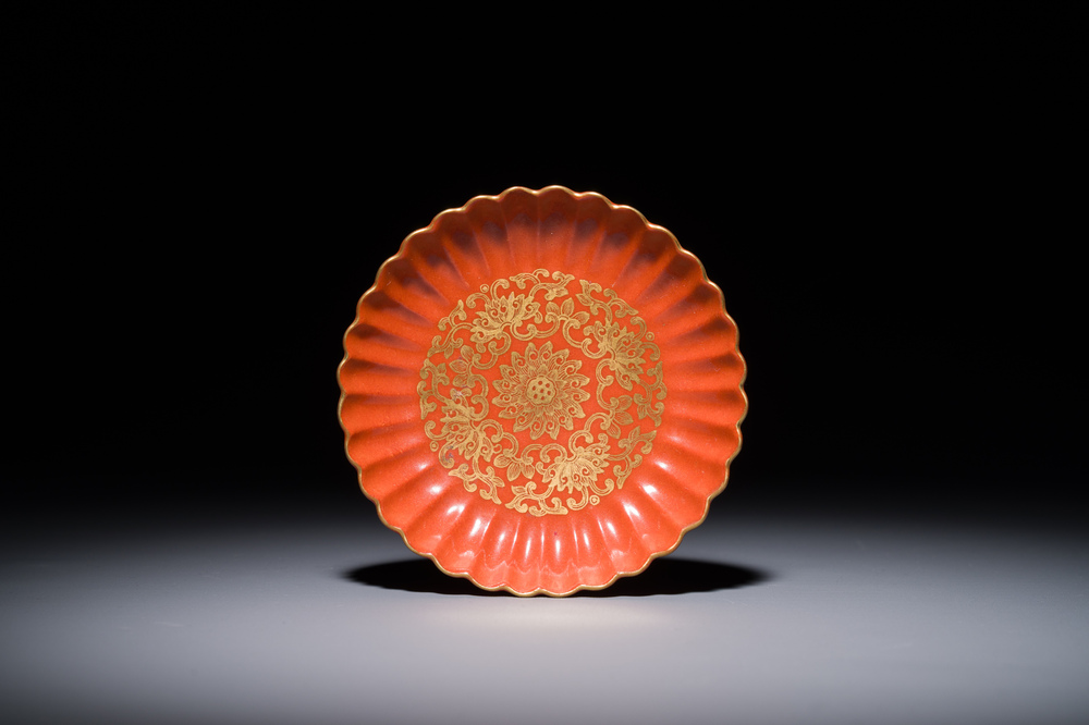 A Chinese coral-red-glazed gilt-decorated 'lotus scroll' saucer, Jiaqing mark, Republic