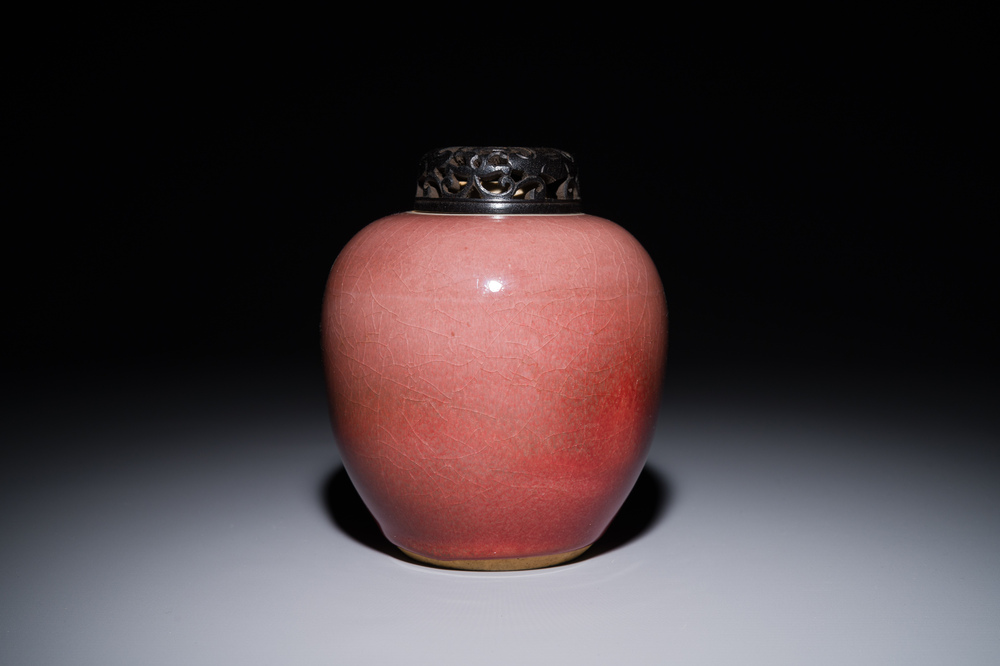 A Chinese monochrome copper-red-glazed ginger jar with a reticulated wooden cover, 18/19th C.