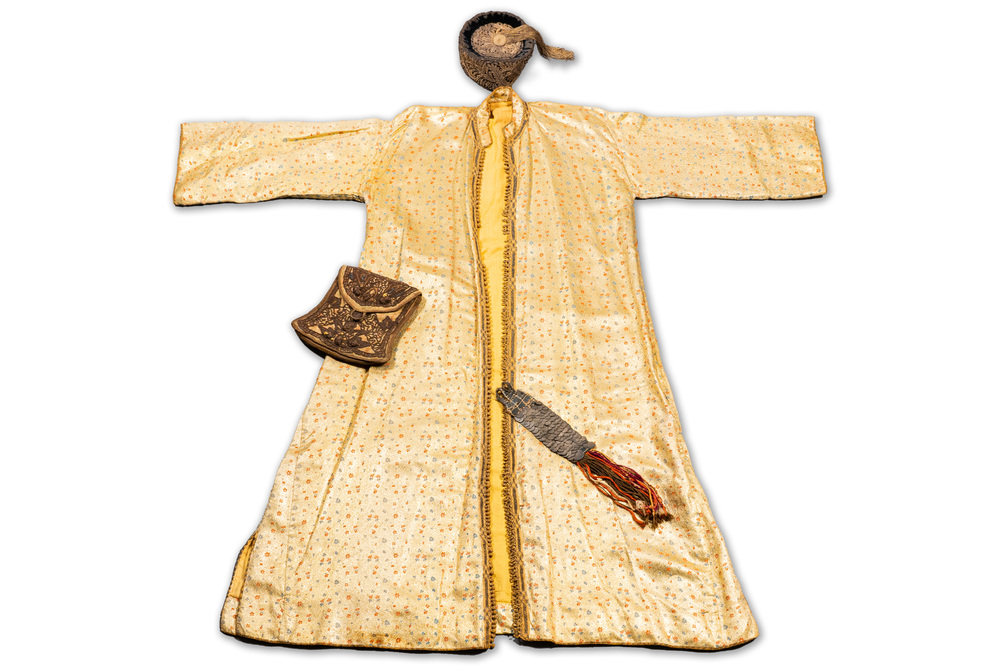 An Iranian gold-thread-embroidered silk caftan, a hat, a coin bracelet and a Koran holder, 19th C.