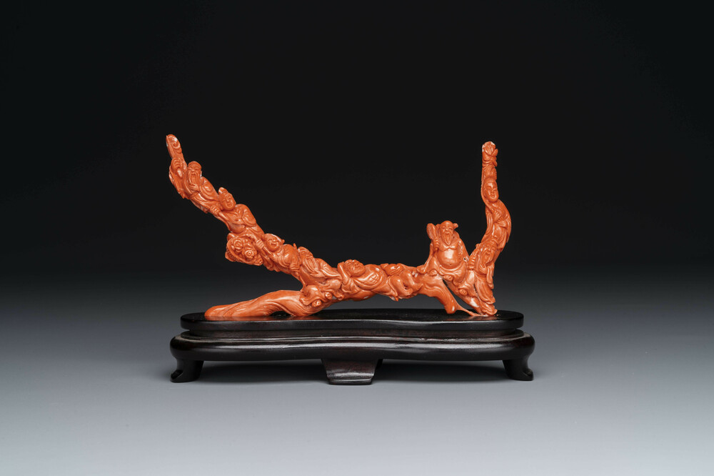 A Chinese red coral 'Eight Immortals' group on wooden stand, 19/20th C.