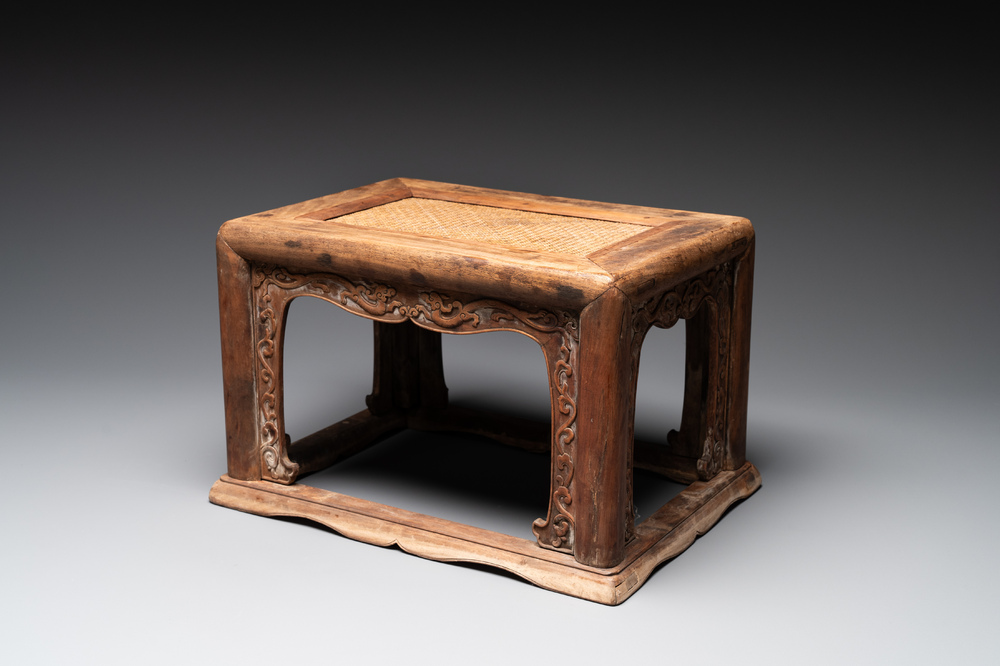 A Chinese rectangular huanghuali wooden stool with 'chilong' design, 17/18th C.