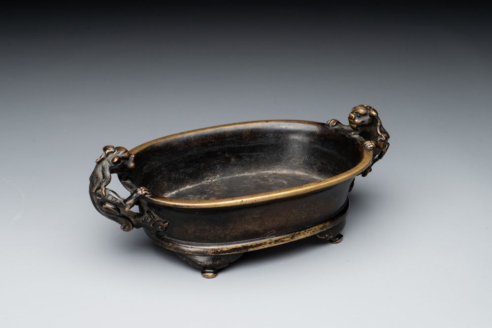 A rare Chinese bronze narcissus basin-shaped censer with dragon handles, Xuande mark, 17th C.