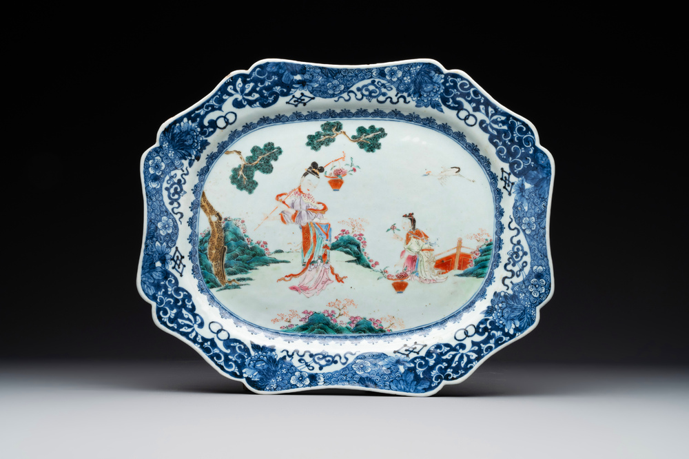A Chinese famille rose 'He Xiangu' charger with a blue and white border, Qianlong