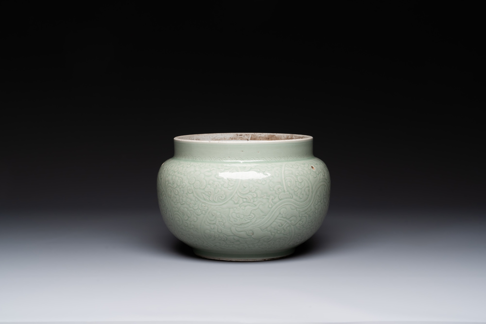 A Chinese monochrome celadon-glazed jar with anhua chilong and floral design, Kangxi