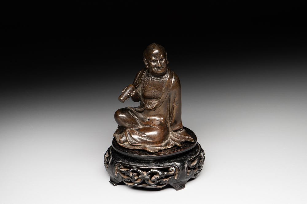 A small Chinese bronze figure of a Luohan, Ming