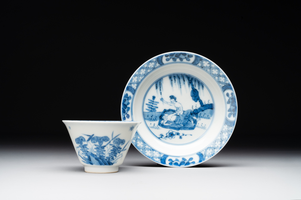 A Chinese blue and white 'erotic' cup and saucer, Kangxi