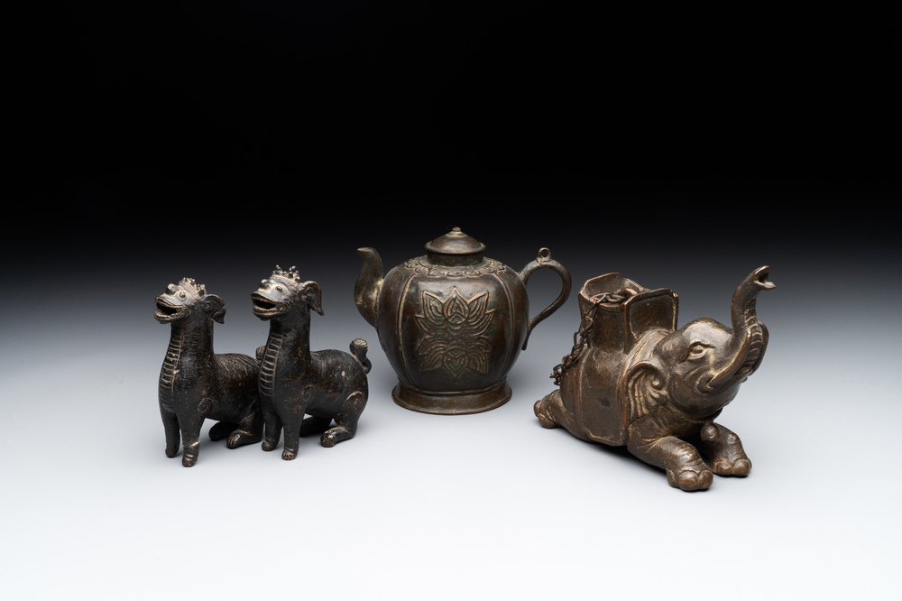 A pair of Chinese bronze mythical creatures and two ewers, Ming