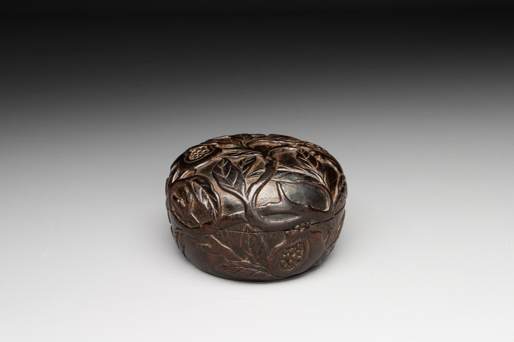 A Chinese huanghuali wooden box and cover with pomegranate design, 17/18th C.