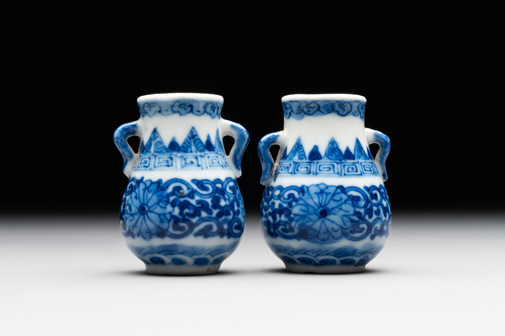 A pair of Chinese blue and white miniature 'hu' vases on wooden stands, Kangxi mark, 19th C.