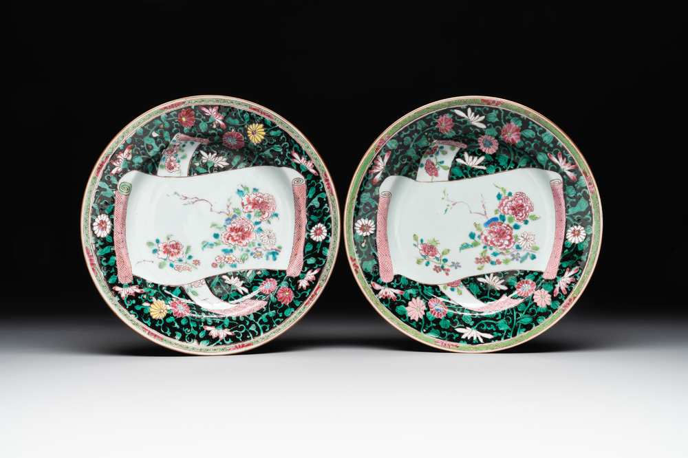 A pair of Chinese famille rose black-ground 'flowers and scrolls' plates, Yongzheng/Qianlong