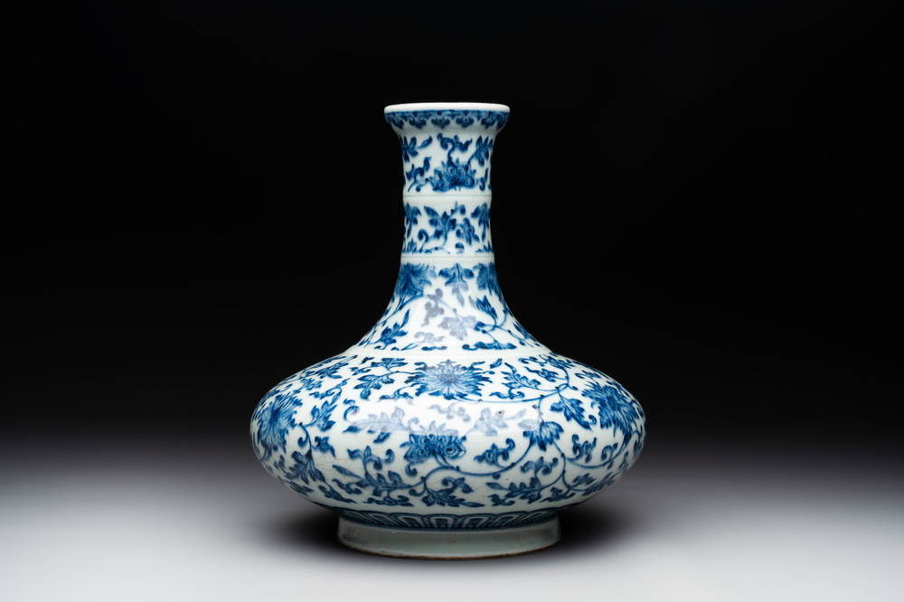 A Chinese blue and white 'lotus scroll' bottle vase, 18/19th C.