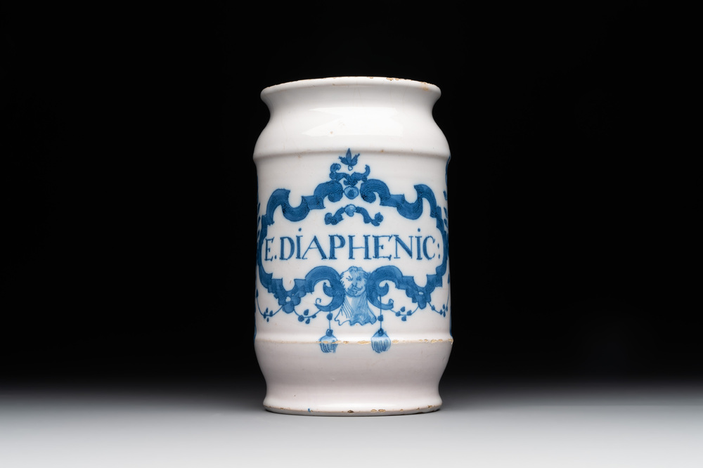 A blue and white Brussels faience albarello with a satyr head, inscribed 'E. DIAPHENIC:', 18th C.