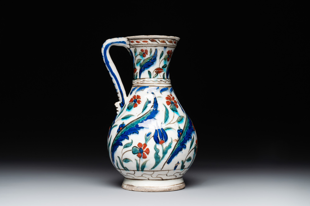 A polychrome and gilt Iznik ewer with tulips, carnation flowers and saz leaves, Turkey, ca. 1600