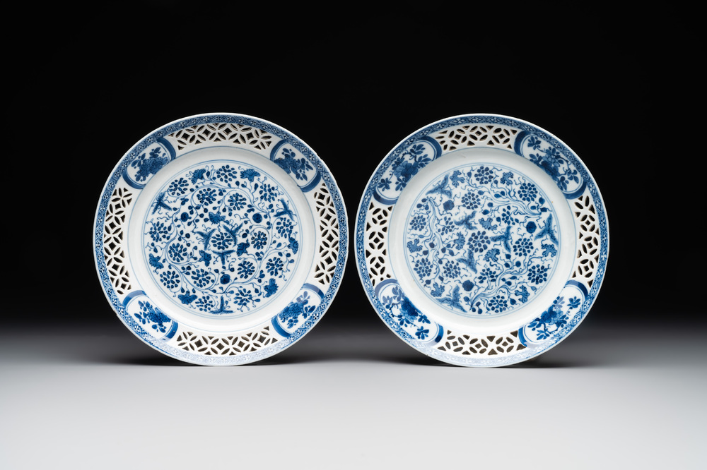 A pair of Chinese blue and white plates with floral design and reticulated border, conical shell mark, Kangxi