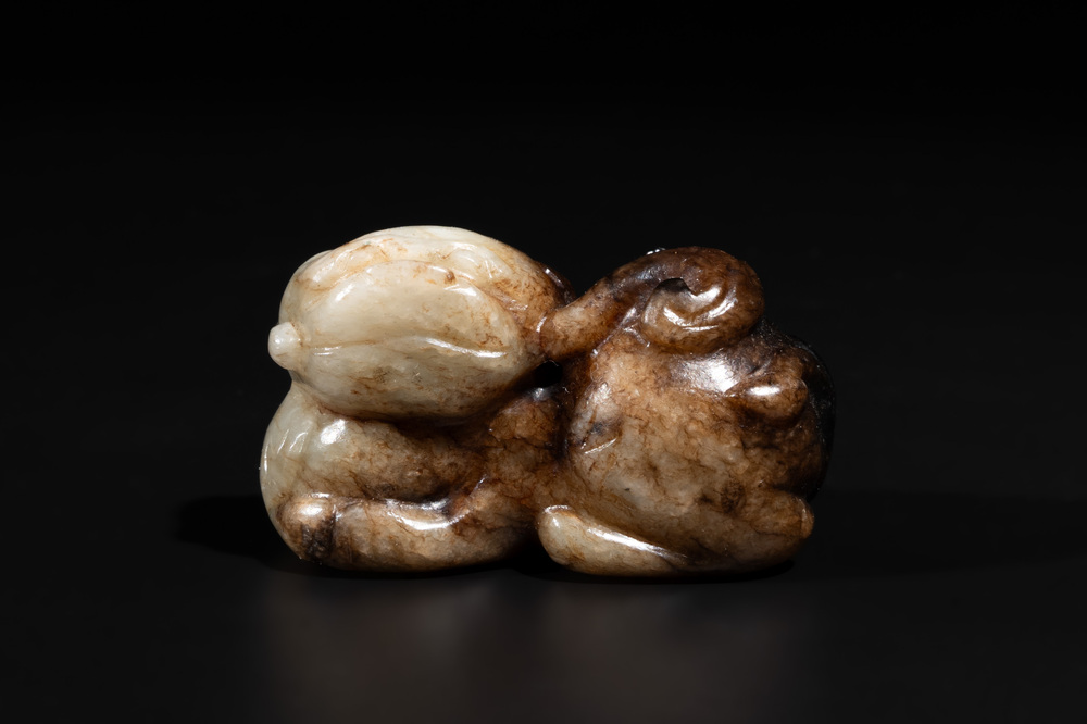 A Chinese celadon and russet jade mythical beast carving, Ming